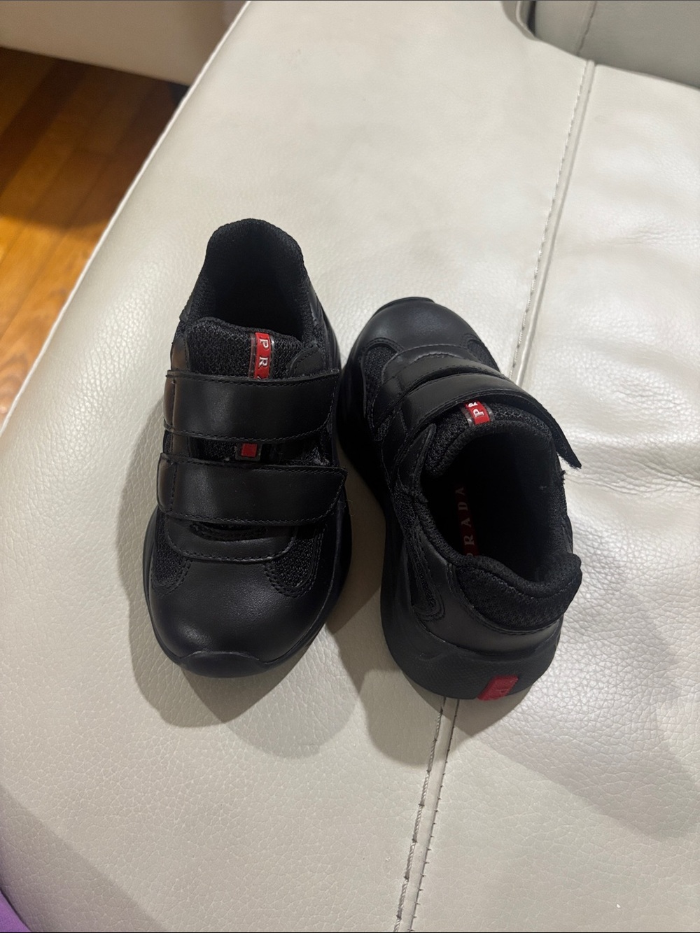 Prada Kids Black Leather Sneakers with Red Logo Accents